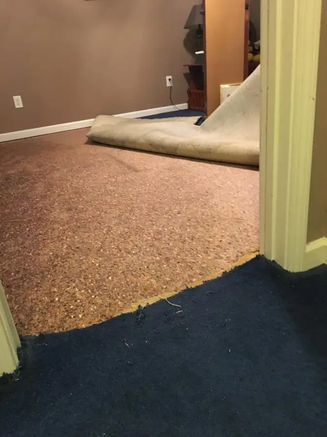 Carpet pad removal revealing water damage during Drying & Dehumidification in Oceanside